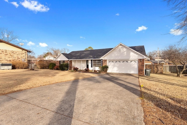 ranch-style home with a garage and a front yard