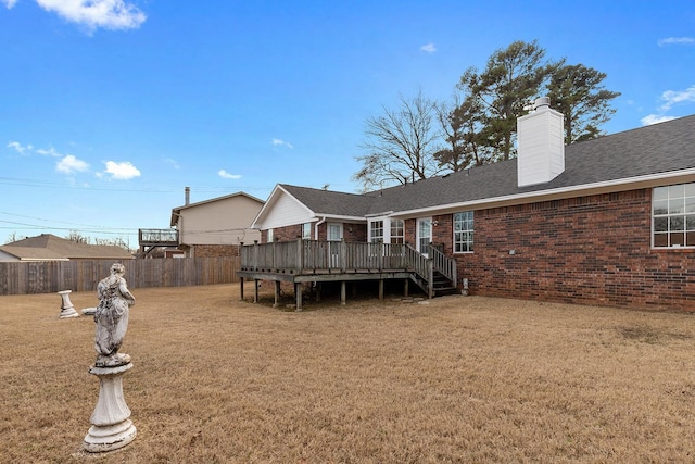 back of house featuring a yard and a deck