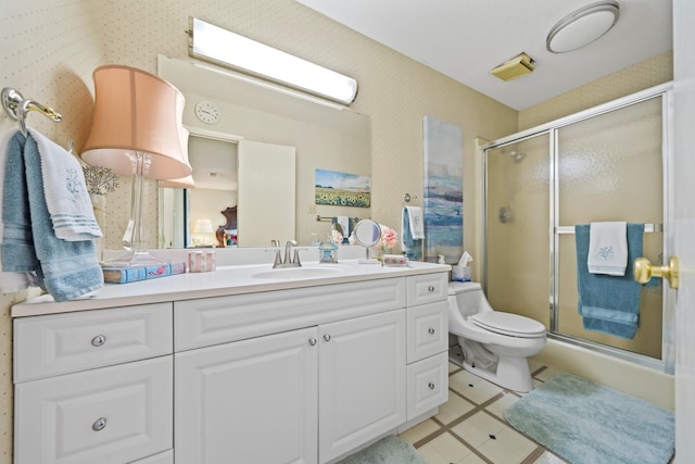 bathroom featuring a shower with door, vanity, tile patterned floors, and toilet