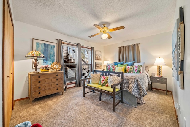 carpeted bedroom featuring a textured ceiling and ceiling fan