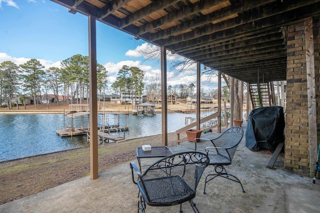 view of patio with a water view, a boat dock, and grilling area