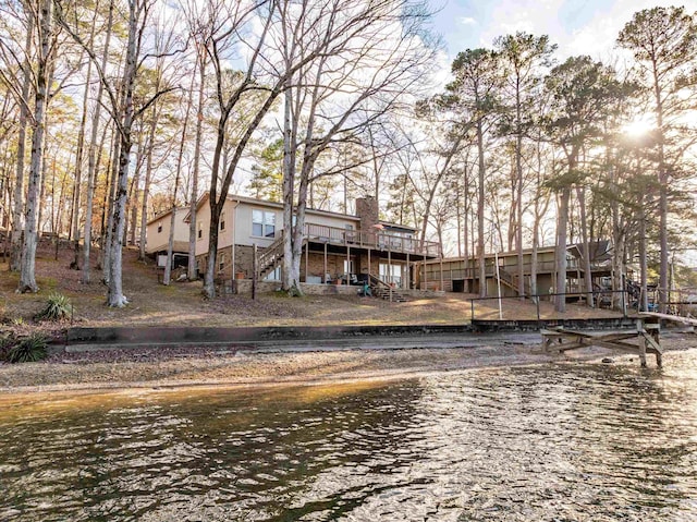 back of property featuring a water view