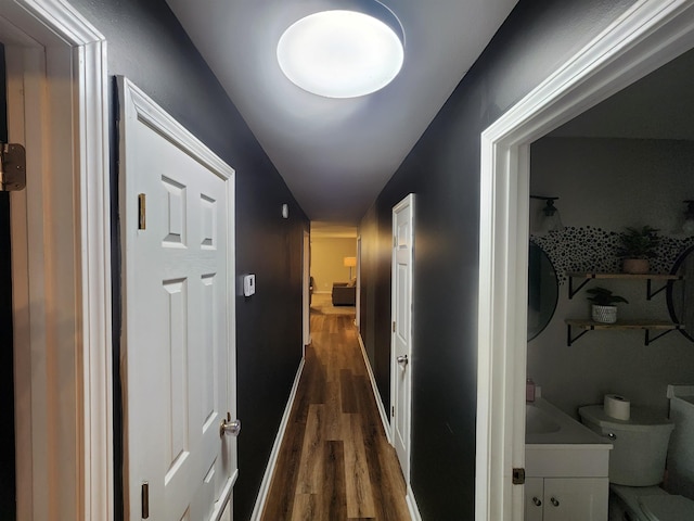 hall featuring dark wood finished floors and baseboards