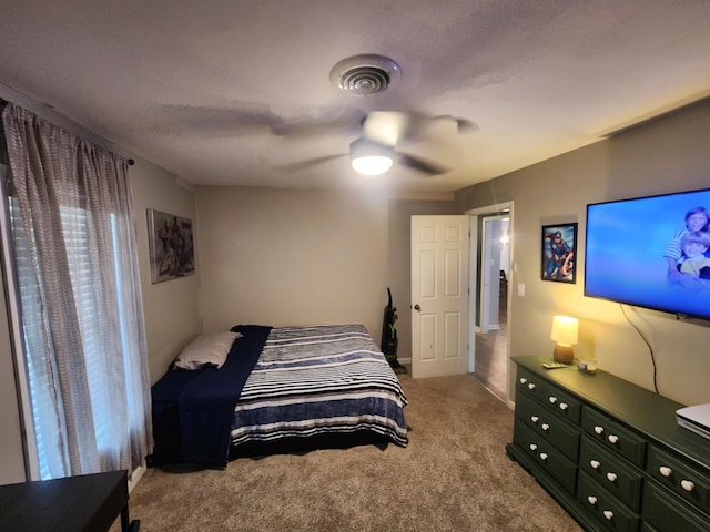 carpeted bedroom with ceiling fan and visible vents