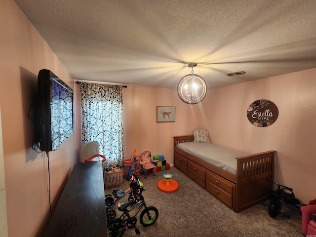 carpeted bedroom with a textured ceiling and visible vents