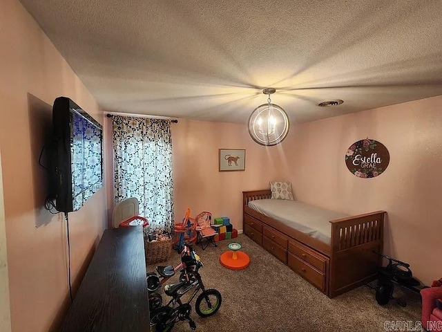 bedroom featuring carpet floors, visible vents, and a textured ceiling