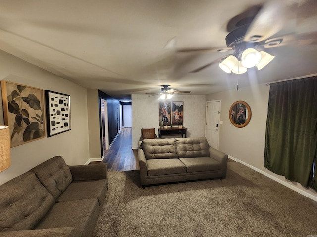 living room featuring a ceiling fan, baseboards, and wood finished floors