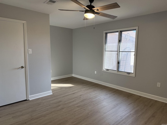 unfurnished room featuring ceiling fan and hardwood / wood-style floors