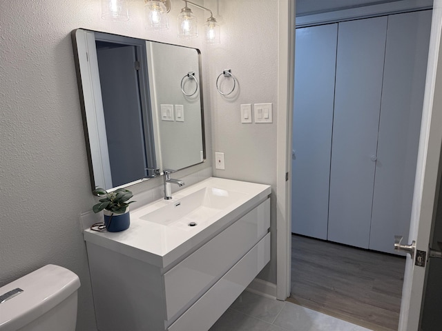 bathroom with vanity, tile patterned floors, and toilet