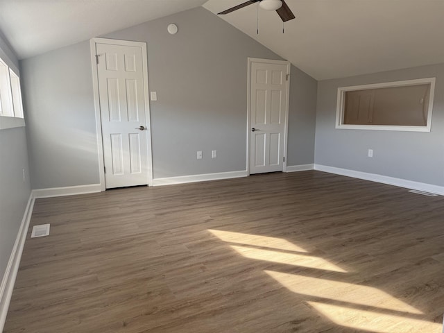 additional living space featuring lofted ceiling, dark hardwood / wood-style flooring, and ceiling fan