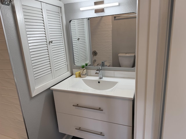 bathroom featuring vanity and toilet