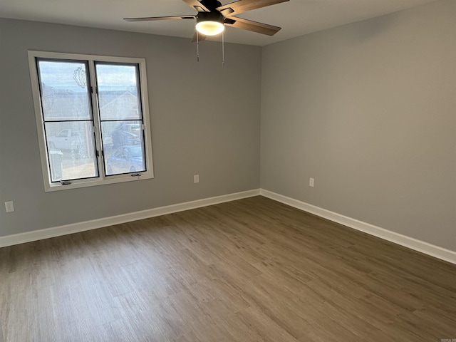 unfurnished room with ceiling fan and dark hardwood / wood-style floors