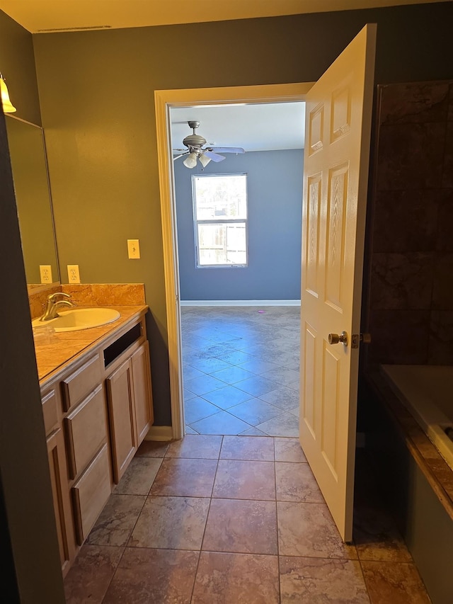 bathroom featuring tile patterned flooring, vanity, and ceiling fan