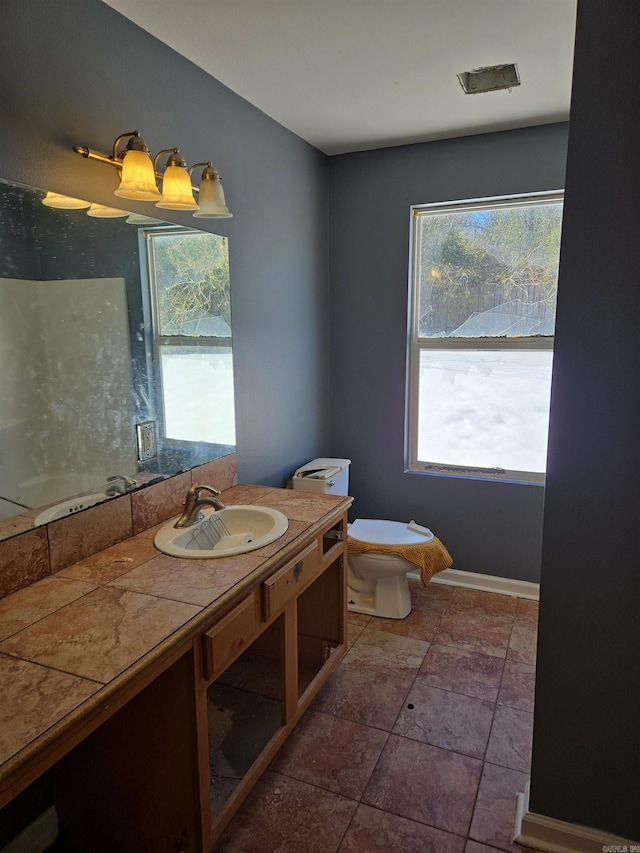 bathroom featuring vanity, toilet, and tile patterned flooring