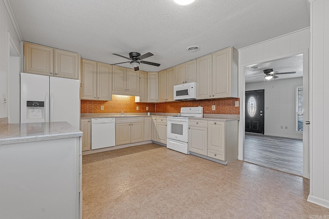 kitchen with ceiling fan, white appliances, sink, and a textured ceiling