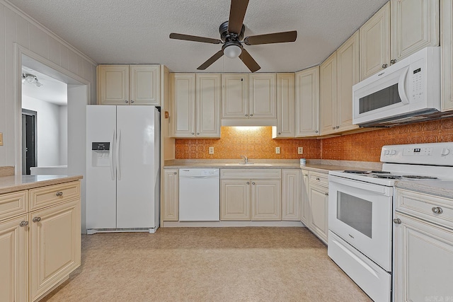 kitchen featuring sink, white appliances, ceiling fan, a textured ceiling, and cream cabinetry