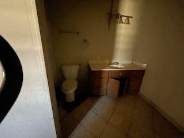 bathroom with tile patterned floors, vanity, and toilet