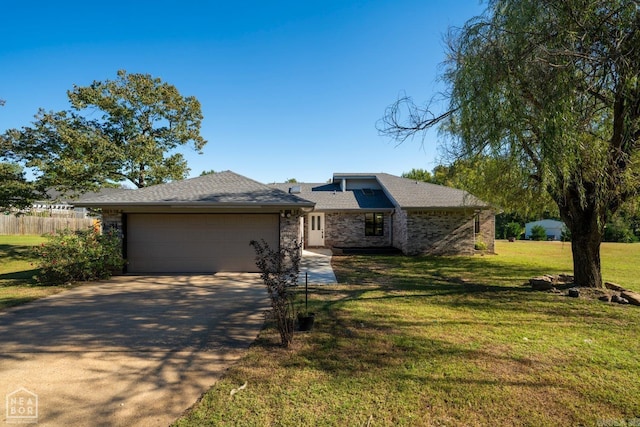 view of front of property with a garage and a front yard