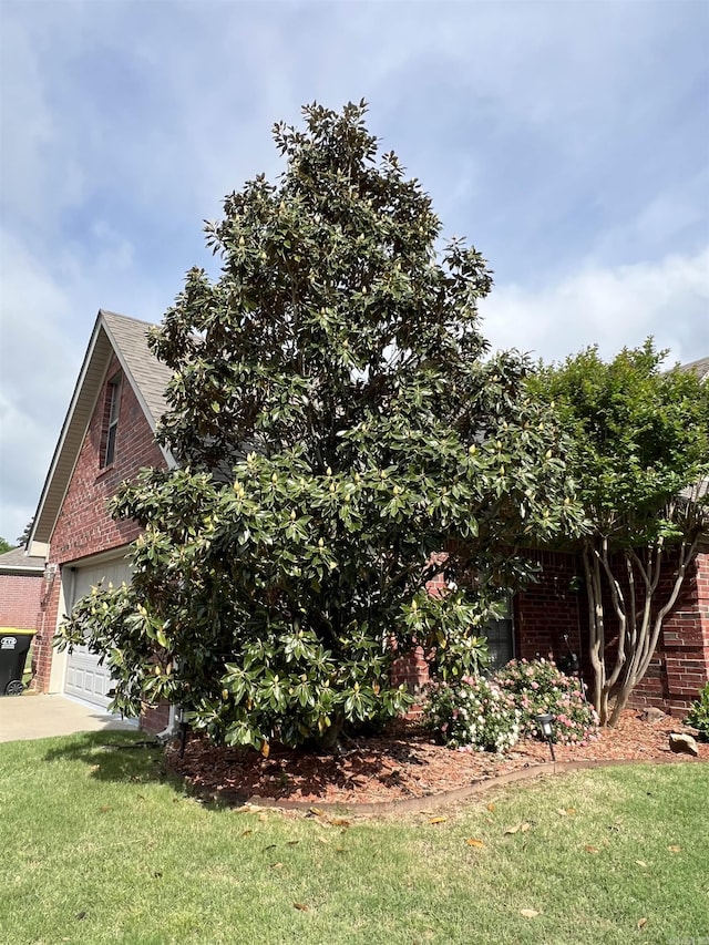 3 N Starlite Dr, Mayflower, AR 72106 - view of property exterior with a garage, brick siding, a shingled roof, a lawn, and driveway