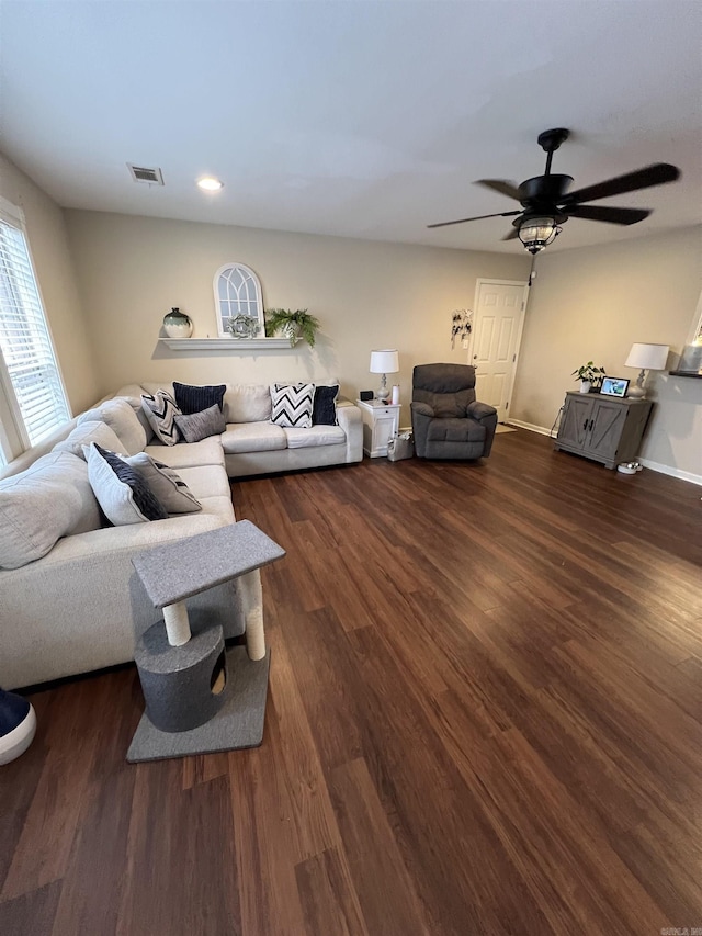 living room with dark hardwood / wood-style floors and ceiling fan