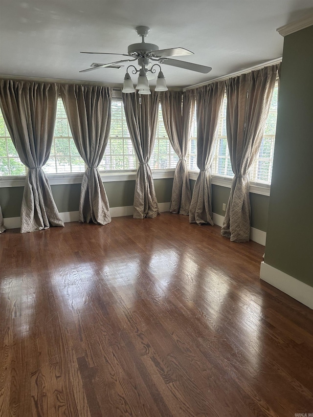 unfurnished room featuring dark wood-type flooring and ceiling fan