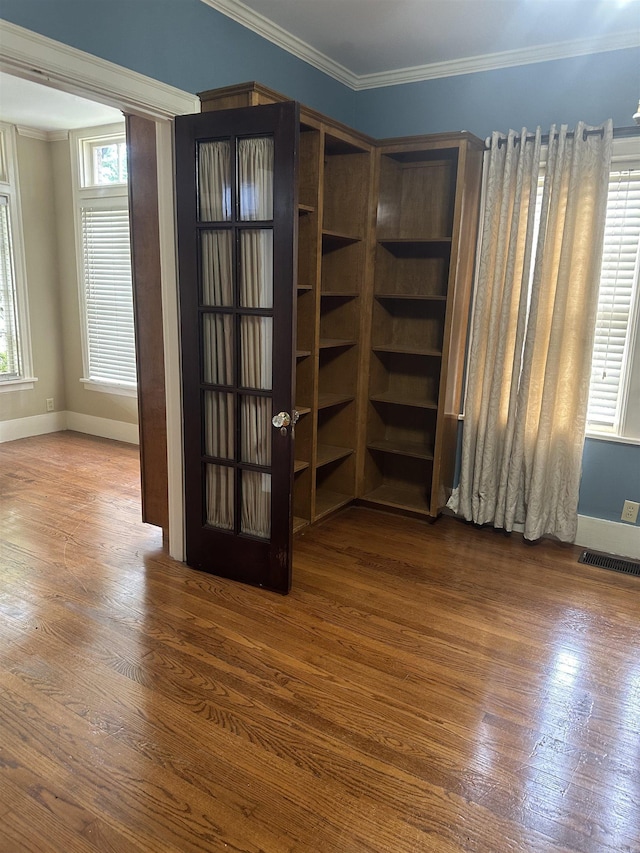 interior space featuring crown molding and dark hardwood / wood-style floors