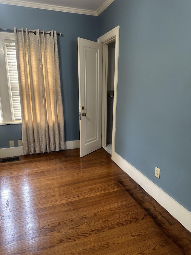 unfurnished room featuring crown molding and dark hardwood / wood-style flooring