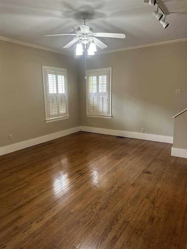 empty room featuring crown molding and a healthy amount of sunlight