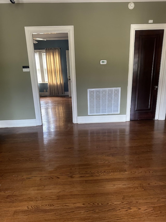 spare room with dark wood-type flooring