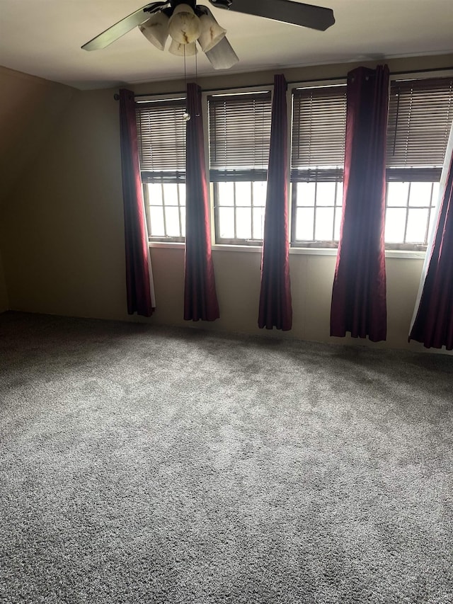 empty room featuring carpet flooring and ceiling fan