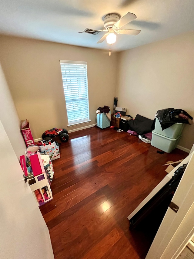 miscellaneous room with dark wood-type flooring and ceiling fan