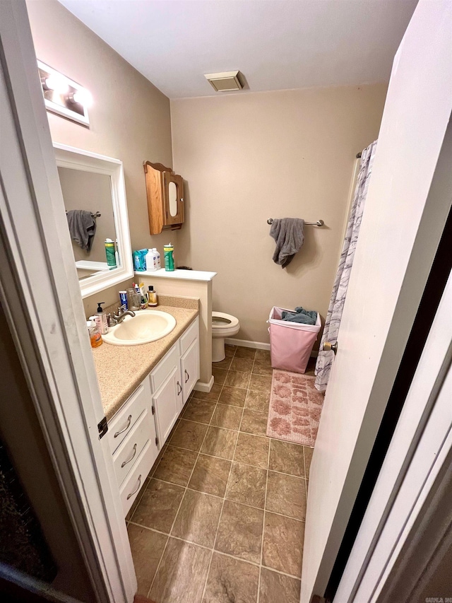 bathroom with vanity, tile patterned floors, and toilet