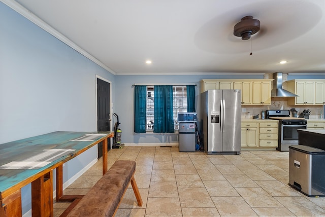 kitchen featuring crown molding, appliances with stainless steel finishes, wall chimney range hood, cream cabinets, and backsplash