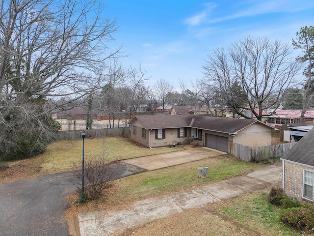 ranch-style home with a garage and a front lawn