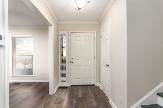 foyer featuring ornamental molding, dark hardwood / wood-style floors, and a textured ceiling