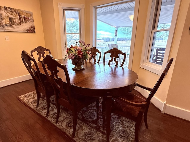 dining area featuring dark wood-type flooring and a wealth of natural light