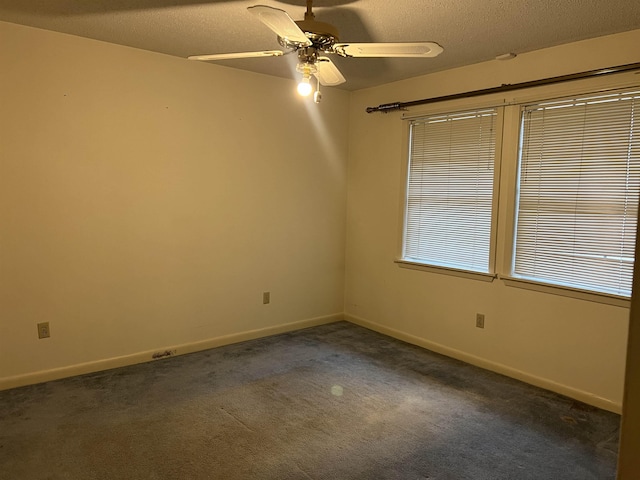 carpeted empty room featuring ceiling fan and a textured ceiling