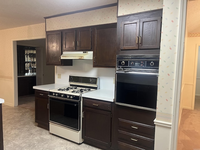 kitchen featuring dark brown cabinets, white range with gas cooktop, and oven