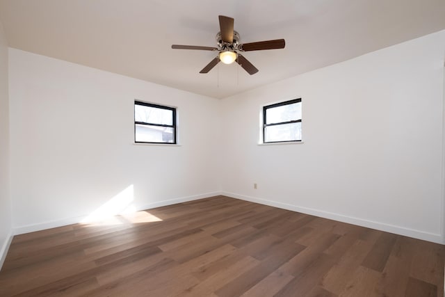 unfurnished room with dark wood-type flooring and ceiling fan