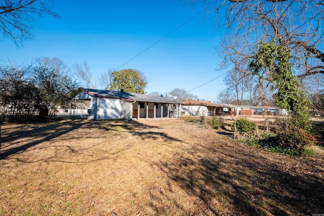 back of property featuring a lawn