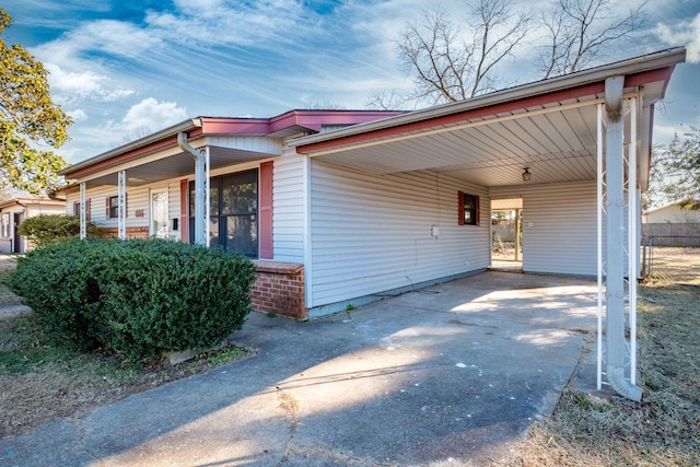 view of side of home with a carport