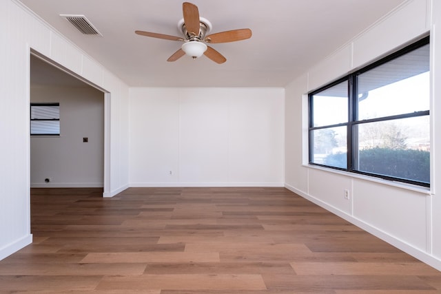 empty room featuring hardwood / wood-style flooring and ceiling fan