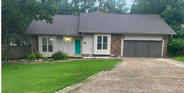 view of front of home with a garage and a front lawn