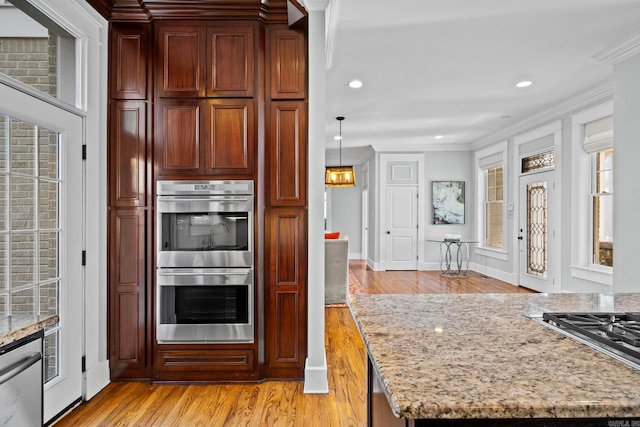 kitchen with stainless steel appliances, crown molding, light hardwood / wood-style flooring, a healthy amount of sunlight, and light stone countertops