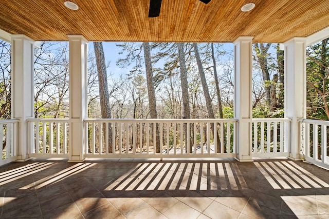 unfurnished sunroom with ceiling fan and wood ceiling