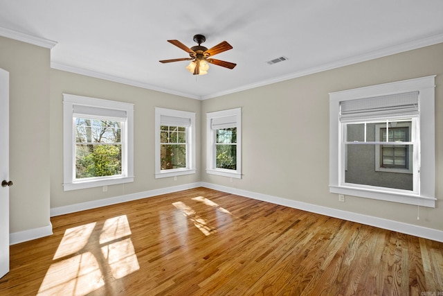 spare room featuring ornamental molding, light hardwood / wood-style floors, and ceiling fan