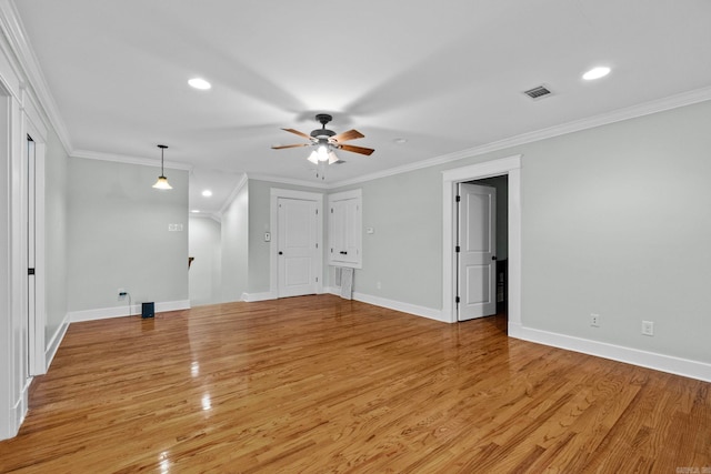 spare room with crown molding, ceiling fan, and light hardwood / wood-style flooring