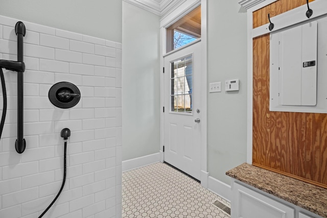 mudroom featuring crown molding and electric panel