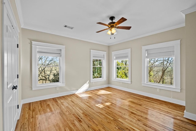 empty room featuring ornamental molding, ceiling fan, and light hardwood / wood-style floors