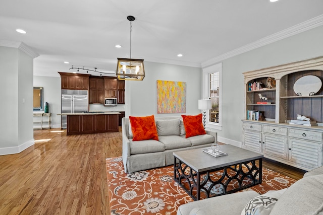 living room featuring ornamental molding and light hardwood / wood-style floors